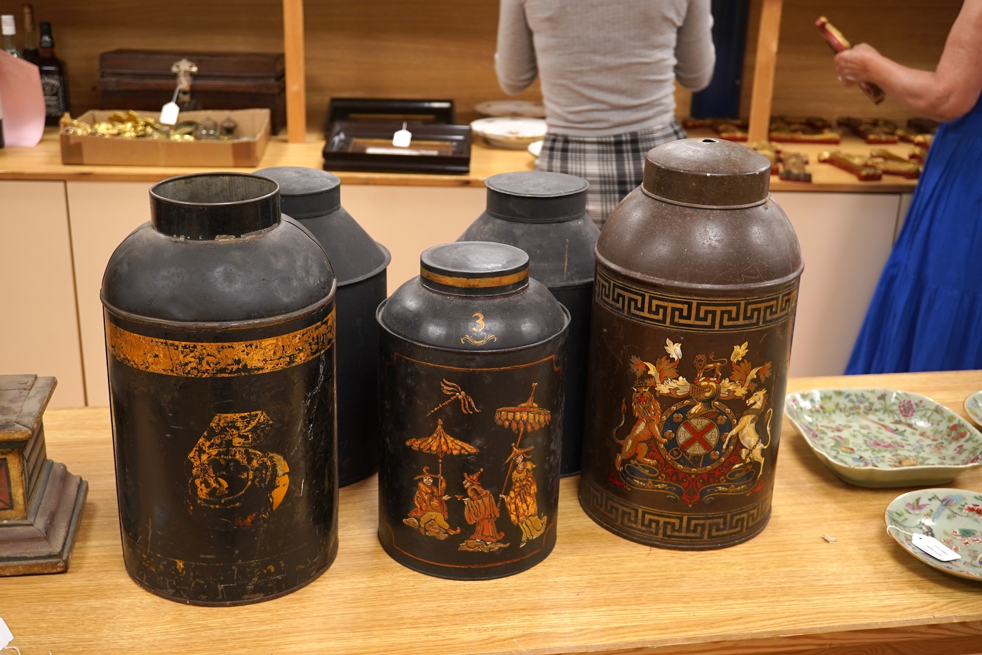 Five 19th century toleware tea canisters, largest 43cm